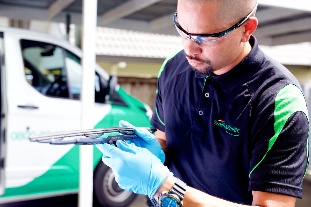 guy checking car windscreen wipers